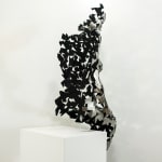Stainless steel sculpture of a person sitting upright by slate gray gallery artist David Davis