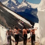 Color photo of four female skiers in bikini tops hiking their skis up ophir pass by slate gray gallery photographer Brett Schreckengost