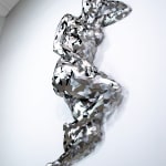 Stainless steel sculpture of a person laying on their side with their arm under their head by slate gray gallery artist David Davis