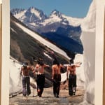 Color photo of four female skiers in bikini tops hiking their skis up ophir pass by slate gray gallery photographer Brett Schreckengost