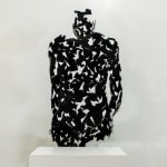 Stainless steel sculpture of a person sitting upright by slate gray gallery artist David Davis