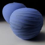 blue textured earthenware vessel with one other blue vessel in the background by potter Nicholas Bernard