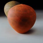 bright red earthenware vessel with one other vessel in the background by potter Nicholas Bernard