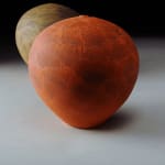bright red earthenware vessel with one other vessel in the background by potter Nicholas Bernard