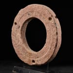 Ancient Red Stone Village Millstone on a wooden stand , most probably from Ghana.,