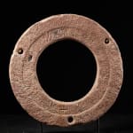 Ancient Red Stone Village Millstone on a wooden stand , most probably from Ghana.,