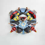 sculpture of a multiple shark heads, humans, and boats coming out towards the viewer