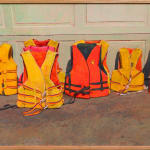 Painting of a bunch of bright orange and yellow life vest on the ground leaning up against a garage door.