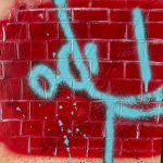 light blue robot outline against a red brick wall