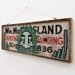 GATS character painted on a wooden sign with black and red writing