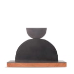 Scott Albrecht steel sculpture - two semi circles, smaller one balanced on larger one. Wood base