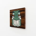 Painting by GATS of GATS character in white and green on a wooden background