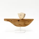 Wooden sculpture of a bird on a boat shaped object by Hyland Mather
