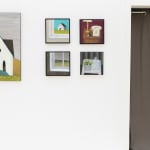 photo of various paintings hung on a white wall