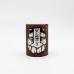 Rusted can with GATS character painted in black and white