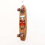 Brown wooden vintage skateboard with a red face GATS character with an atomic bomb smoke ring coming out of the top of his head painted on the bottom of the board