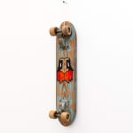 Wooden vintage skateboard with GATS character with an orange beard painted on it