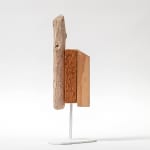 Wooden sculpture with a piece of drift wood and two other flat pieces of wood side by side on a metal stand by Hyland Mather