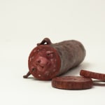 Stephen Morris "Salami" ceramic sculpture of realistic red salami with two pieces cut out revealing a face