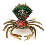 Sculpture of a brass crab with an underwater scene inside of the crab shell