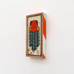 GATS character with orange and red face and a beard made out of green chains painted on a white piece of wood.