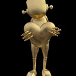 front view of a gold robot statue holding a large heart with his two hands