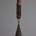 detail of the bronze bell attached to the mixed media bat sculpture by Lucien Shapiro