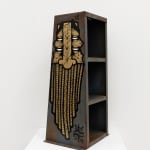 Metal shelf with GATS character painted on the sides and a metal chain painted on the back