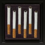 painting of six cigarettes staggered in a line in a black frame