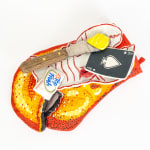 Ceramic sculpture of a lobster claw shaped oven mitten with a lobster shaped plate on top of it. On top of the plate is a knife with butter, an ace of spades playing card and a wet wipe.
