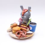 Vinyl Totoro figure with a platter of classic NYC food