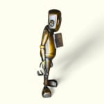 right side view of a bronze robot statue with an open door on his chest revealing a heart