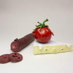 Stephen Morris "Tomato" ceramic sculpture of realistic tomato with pig-like facial features