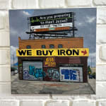 Painting by Valeri Larko of a building with advertising signs on it