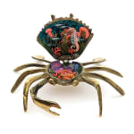 Sculpture of a brass crab with an underwater scene inside of the crab shell
