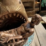 sculpture of a shark with a man in his mouth
