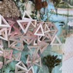 Detail image of Gregory Euclide's "Spangle." Hollow pyramids made by paper and small branches above and under them.