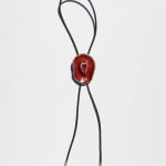 Ceramic bolo tie of a red cowboy hat on a black leather tie