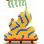 Chiaozza paper pulp sculpture of abstract yellow and blue vase with comb-like green plant on small wooden table base