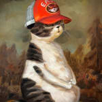 cat sitting upright with an orange hat
