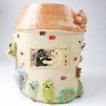 Katie Kimmel ceramic vase made to look like a house with dogs surrounding it
