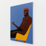 Man with red hair sitting in yellow chair holding a coin by Jillian Evelyn