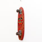 Red vintage wooden skateboard with GATS character with red hearts for eyes painted on the bottom of it