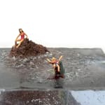 sculpture of a woman on a rock and another woman being eaten by a shark in the water