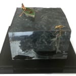 sculpture of a person rowing a boat and another person swimming with a shark coming to eat them