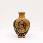 GATS character painted on a metal brown vase in black
