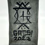 inside of tin decorated with GATS mask and symbols