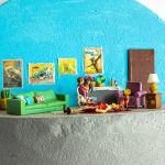 miniature diorama by Abigail Goldman of a woman and her three cats next to a bloody dead man