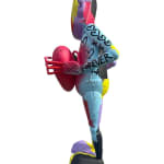 left side view of a multi-colored robot statue holding a heart