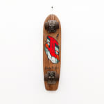 Brown wooden vintage skateboard with a slanted red face GATS character painted on the bottom of the board